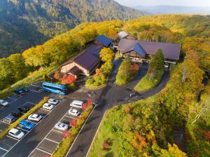 an aerial view of a house with cars parked in a parking lot at Hakkoda Hotel in Aomori