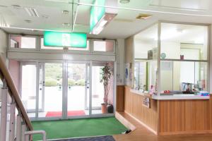 a hospital lobby with a sign on the ceiling at Oyabe City Cycling Terminal in Oyabe