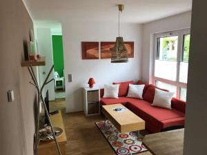 a living room with a red couch and a table at Louisenstraße 31 in Dresden