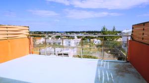 a balcony with a view of a city at Palmyre Residence 7 & 8 LICENSED BY TOURISM AUTHORITY 10071 in Flic-en-Flac