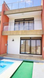 a house with a swimming pool in front of it at Palmyre Residence 7 & 8 LICENSED BY TOURISM AUTHORITY 10071 in Flic-en-Flac