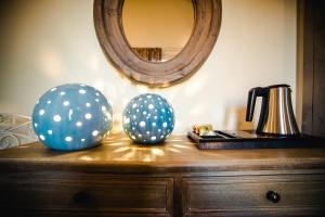 two balls on top of a dresser with a mirror at Podere Zampiera Vecchia in Imola