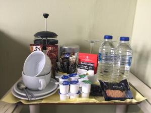 a tray with cups and water bottles on a table at Invercloy Guest House in Oban