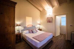a bedroom with a large bed and a window at Podere Zampiera Vecchia in Imola