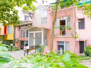 a pink building with a bench in front of it at YES Varna Studios in Varna City