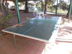 a ping pong table sitting on a patio at Al Villino Sunrise in villa con piscina ed idromassaggio in SantʼAlfio