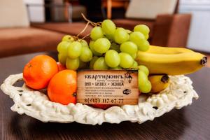 a bowl of fruit sitting on a table at Apartment TwoPillows on Lenina 56 in Vorkuta