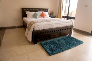 
a bed that has a blanket on it at MeghBrishti Bari in Raichak

