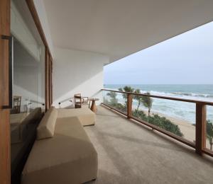 a room with a balcony with a view of the ocean at Riff Hikkaduwa in Hikkaduwa