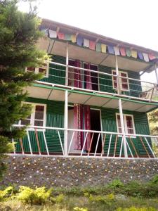 a building with balconies on the side of it at Vamoose Green Valley Village Resort in Pedong