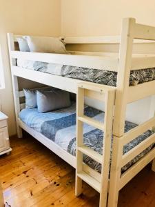 מיטה או מיטות קומותיים בחדר ב-Cosy Private Cottage