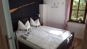 a bedroom with a bed with white sheets and pillows at Haus zum wilden Manne in Erfurt