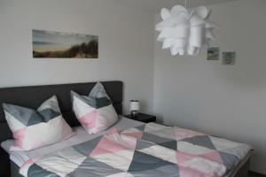 a bedroom with a bed with colorful pillows at Ferienwohnung Ida in Polch