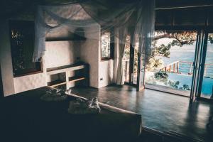 a room with a bed with a view of the ocean at Langkhai Garden in Ko Tao