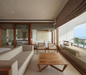 a living room with a couch and a table at Riff Hikkaduwa in Hikkaduwa