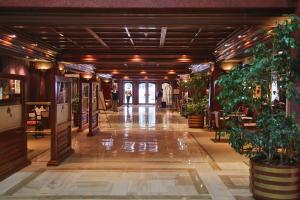 a hallway with potted plants in a building at Hotel Plaza San Francisco in Santiago +38 photos