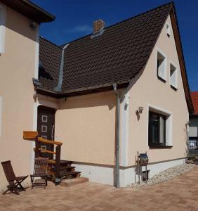 un edificio bianco con portico e una casa di Köhlers Ferienhaus a Schöppenstedt