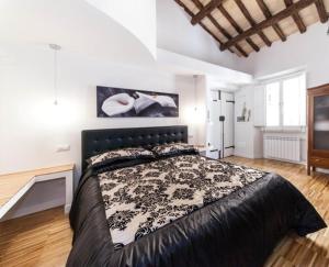 a bedroom with a large bed with a black headboard at Urbana 33 in Rome
