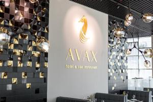 a wall with a sign for a hotel and spa restaurant at Grand Spa Hotel Avax in Krasnodar