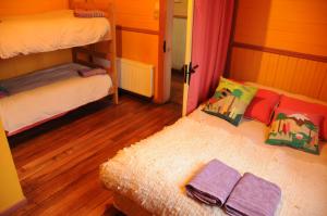 a bedroom with two bunk beds and a mirror at Hostal Epu Pewen in Curacautín