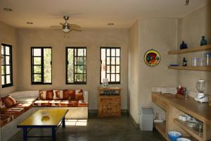 a living room with a couch and a table at Sole Caliente in Todos Santos