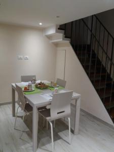 a dining room with a table and chairs and a staircase at B&B MARIO PAGANO in Brindisi
