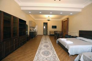 a hotel room with a bed and a kitchen at Center Villa Kutaisi in Kutaisi