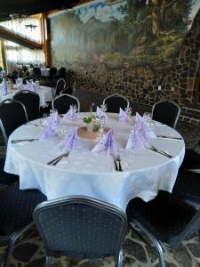 un tavolo con tovaglioli bianchi e viola di Pensiune Restaurant la Pogace a Săpînţa