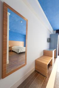 Un pat sau paturi într-o cameră la Hotel Zodiaco