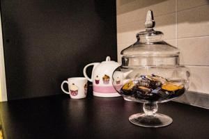 a glass bowl filled with candy on top of a table at Little House in Modugno +12 photos