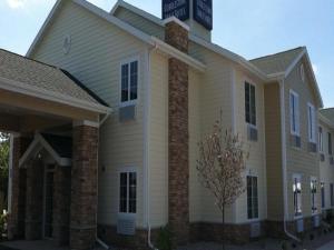 a building with a sign on top of it at Cobblestone Inn & Suites - Harvey in Harvey