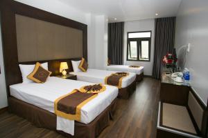 Postel nebo postele na pokoji v ubytování Mộc Trà Hotel Bãi Cháy Hạ Long