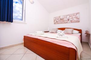 Postel nebo postele na pokoji v ubytování Apartmani Tea