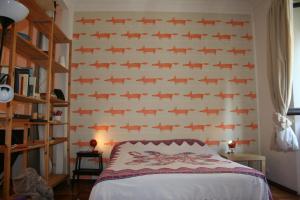 a bedroom with a wall with a pattern of fish at Appartamento Conte Rosso in Turin