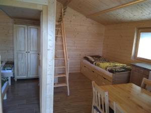 a room with a bed and a ladder in a cabin at Chata Nový Přerov in Nový Přerov