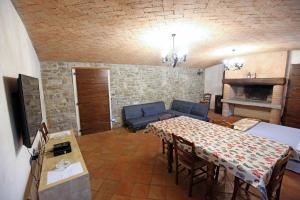 a living room with a table and a couch at Casa Santina in Girasole