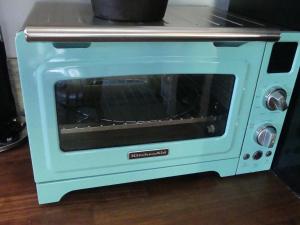 a blue toaster oven sitting on top of a table at Cute Cabin - The Evergreen in Cannonville