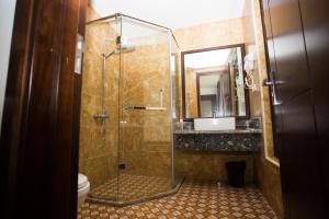 a bathroom with a shower and a toilet and a sink at Moc Tra Hotel Tuan Chau Hạ Long in Ha Long +37 photos