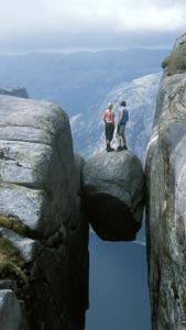 two people standing on top of a rock formation at Sirdal in Tjørhom