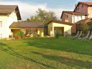a house with a yard with chairs in it at House Sekulic in Grabovac