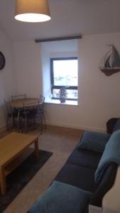 a living room with a couch and a table at Penbryn Holidays, Barmouth in Barmouth