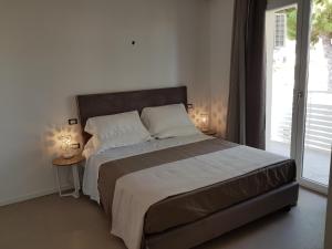 Tempat tidur dalam kamar di Residence Hotel Venus Suites
