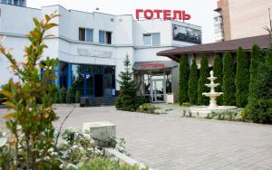 a hotel with a fountain in front of a building at Faraon Hotel in Ivano-Frankivsʼk