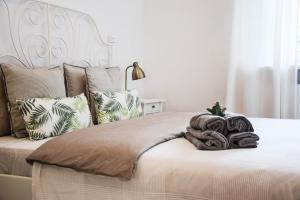 a bedroom with a large white bed with pillows at CityBrejk Hubska Wrocław in Wrocław