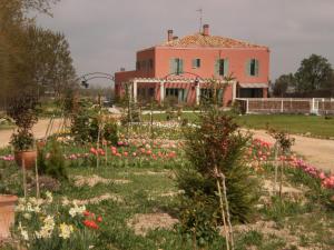 a large building with a flower garden in front of it at Hotel Santa Coloma del Camino in Olmillos de Sasamón