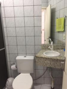 a bathroom with a toilet and a sink at Pousada Almeida in Florianópolis