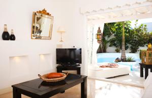 a living room filled with furniture and a table at KATIS Villas Boutique Fuerteventura in Corralejo