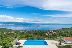 an image of a swimming pool with a view of the water at Villa Visum in Poljane