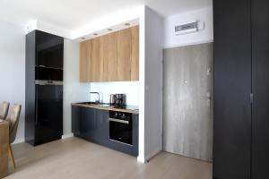 Kuchyň nebo kuchyňský kout v ubytování Calamo Park, Apartamenty z klimatyzacją