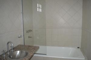 a bathroom with a shower and a sink and a tub at Rio Negro Loft in Viedma +10 photos